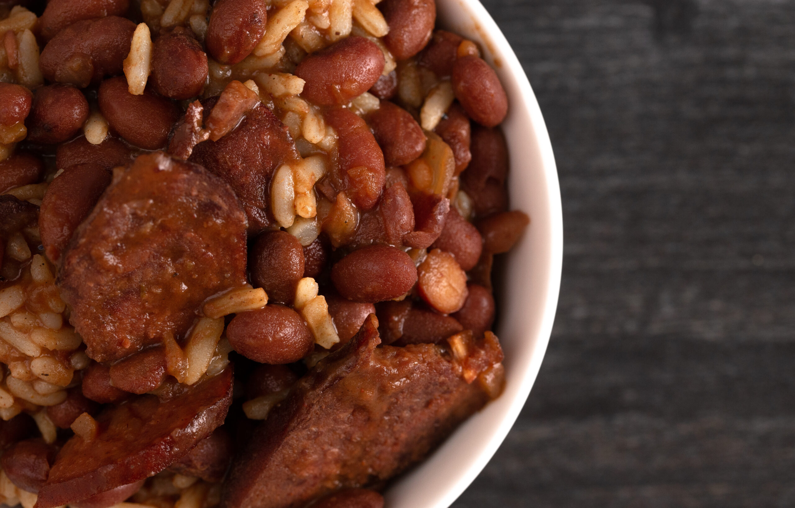 A bowl of red beans and rice with sausage